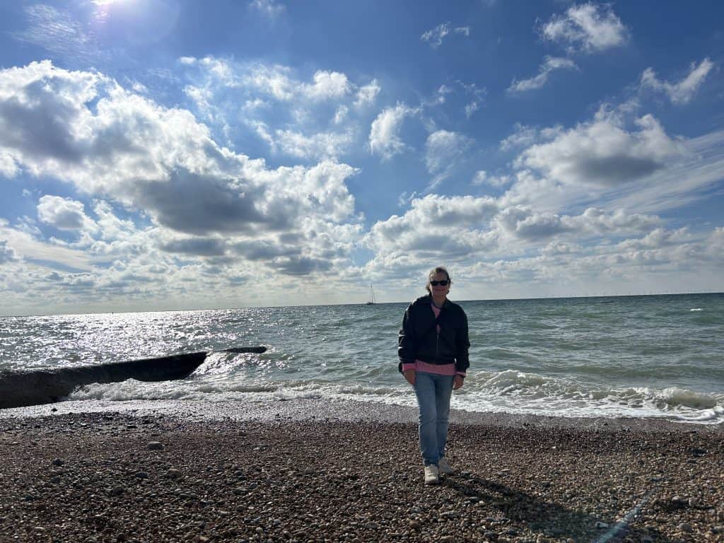About 2 Katherine porter standing on a beach by the sea